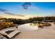 Luxury backyard oasis featuring a large infinity pool, spa, and fire pit at 23238 N 94Th Pl, Scottsdale, AZ 85255