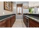 Wet bar with dark wood cabinets and granite countertops at 23238 N 94Th Pl, Scottsdale, AZ 85255