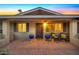 Inviting front porch with brick flooring, blue pots, and wicker chairs at 2444 E Del Rio Dr, Tempe, AZ 85282