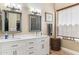 Elegant bathroom with dual sinks, white cabinetry, framed mirrors, and wood-look flooring for a spa-like feel at 31016 N 42Nd Way, Cave Creek, AZ 85331