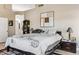 Spacious bedroom with a large decorative piece of art, king bed, and a view into the Primary bath at 31016 N 42Nd Way, Cave Creek, AZ 85331