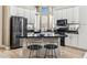 Spacious kitchen with black appliances, white cabinets, a breakfast bar, and ample natural light, ideal for cooking and gathering at 31016 N 42Nd Way, Cave Creek, AZ 85331