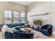Cozy living room featuring a large window for natural light and a comfortable sectional sofa with accent chairs at 31016 N 42Nd Way, Cave Creek, AZ 85331