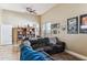 Spacious living room showcasing a ceiling fan, bookshelves and entertainment themed decor, adding character to the home at 31016 N 42Nd Way, Cave Creek, AZ 85331