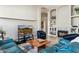 Comfortable living room showcasing a fireplace, built-in shelving, and a cozy blue leather sectional sofa at 31016 N 42Nd Way, Cave Creek, AZ 85331