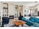 Inviting living room featuring a stone fireplace, built-in shelves, and a comfortable blue leather sectional at 31016 N 42Nd Way, Cave Creek, AZ 85331