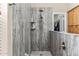 Modern shower featuring stylish wall panels, built-in shelving, and updated hardware with an adjacent walk-in closet at 31016 N 42Nd Way, Cave Creek, AZ 85331