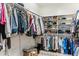 Organized walk-in closet with hanging rods, shelving, and ample storage space for clothes, shoes, and accessories at 31016 N 42Nd Way, Cave Creek, AZ 85331