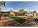 Spacious backyard featuring artificial turf, yard games, a gazebo with a hot tub, and outdoor seating areas at 3132 N 15Th Ave, Phoenix, AZ 85015