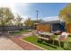 A spacious backyard with a covered lounge area, artificial turf, and fun yard games for outdoor enjoyment at 3132 N 15Th Ave, Phoenix, AZ 85015
