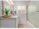Bathroom featuring a vanity with storage, a large mirror, a bathtub with shower, and natural light at 3132 N 15Th Ave, Phoenix, AZ 85015