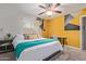 Cozy bedroom featuring a ceiling fan, desk, and stylish accent wall at 3132 N 15Th Ave, Phoenix, AZ 85015