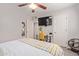 Bedroom with natural light, a desk, television, fan, carpet flooring, and closet for additional storage at 3132 N 15Th Ave, Phoenix, AZ 85015