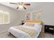 A bright bedroom with a ceiling fan, two large windows, bedside tables, and a comfortable king-size bed at 3132 N 15Th Ave, Phoenix, AZ 85015