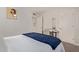 A bright bedroom with a white door, a workstation with a white desk and chair, and a comfortable bed at 3132 N 15Th Ave, Phoenix, AZ 85015