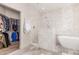 A luxury bathroom features a walk-in shower, a modern tub, and easy access to a walk-in closet at 37327 N 16Th St, Phoenix, AZ 85086