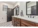 Elegant bathroom with double sinks, marble countertops, and a modern geometric tiled floor at 37327 N 16Th St, Phoenix, AZ 85086