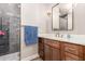 Stylish bathroom featuring a glass enclosed shower with elegant tile and a modern vanity with a marble countertop at 37327 N 16Th St, Phoenix, AZ 85086