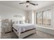 Bright bedroom with a cozy window nook, neutral decor, and a ceiling fan for added comfort at 37327 N 16Th St, Phoenix, AZ 85086