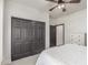 Bedroom featuring black closet doors and a bed with white comforter at 37327 N 16Th St, Phoenix, AZ 85086