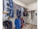 Spacious walk-in closet provides ample storage with clothing racks and organized shelving at 37327 N 16Th St, Phoenix, AZ 85086