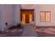 Covered front entrance featuring a wood and beam awning and wooden door with desert landscaping at 37327 N 16Th St, Phoenix, AZ 85086