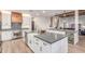 Modern kitchen with white cabinetry, stainless steel appliances, a farmhouse sink, and a bar with a beverage fridge at 37327 N 16Th St, Phoenix, AZ 85086