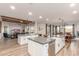 Wide-angle view of an open-concept kitchen with dual islands, dining area, living room, and modern finishes at 37327 N 16Th St, Phoenix, AZ 85086