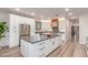 Modern kitchen with white cabinets, stainless steel appliances, large island with stone countertops and breakfast bar at 37327 N 16Th St, Phoenix, AZ 85086