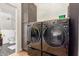 Modern laundry room featuring sleek, front-loading washer and dryer units at 37327 N 16Th St, Phoenix, AZ 85086
