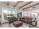 Open-concept living room featuring beamed ceilings, hardwood floors and expansive windows with mountain views at 37327 N 16Th St, Phoenix, AZ 85086