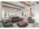 Bright and airy living room featuring beamed ceilings, hardwood floors and open floor plan to kitchen at 37327 N 16Th St, Phoenix, AZ 85086