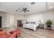 Bright main bedroom features a ceiling fan, neutral walls, and a comfortable bed with stylish linens at 37327 N 16Th St, Phoenix, AZ 85086