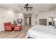 A spacious main bedroom offers a cozy seating area with a leather chair and modern ceiling fan at 37327 N 16Th St, Phoenix, AZ 85086