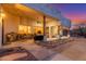 Inviting covered patio with comfortable seating and outdoor grilling area at twilight at 37327 N 16Th St, Phoenix, AZ 85086