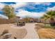 Backyard featuring picnic table, gravel, and a patio with seating, fire pit, and pergola at 41219 W Brandt Dr, Maricopa, AZ 85138