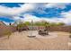 Wide backyard featuring picnic table with umbrella and a stone walkway to seating at 41219 W Brandt Dr, Maricopa, AZ 85138