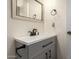 Bathroom featuring a modern vanity, elegant mirror, and sleek fixtures at 41219 W Brandt Dr, Maricopa, AZ 85138