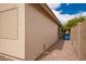 Side view of a home with a beige exterior wall, gravel landscaping, and citrus trees at 41219 W Brandt Dr, Maricopa, AZ 85138