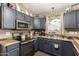 Well-equipped kitchen with modern appliances, ample cabinet space, and stylish countertops at 41219 W Brandt Dr, Maricopa, AZ 85138