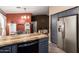 Stylish kitchen featuring stainless steel appliances, shaker cabinets and view to the sitting area at 41219 W Brandt Dr, Maricopa, AZ 85138