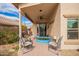 Relaxing covered patio with comfortable seating, ceiling fan, and a playful pool at 41219 W Brandt Dr, Maricopa, AZ 85138