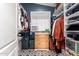 Spacious walk-in closet with custom shelving, storage, and patterned flooring at 41219 W Brandt Dr, Maricopa, AZ 85138