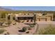 Stunning desert home featuring mountain views, lush landscaping, and a spacious three-car garage at 4185 S Redtail Trl, Gold Canyon, AZ 85118