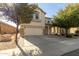 Two-story house with a beige exterior, two-car garage, and landscaping at 44231 W Roth Rd, Maricopa, AZ 85138