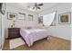 Cozy bedroom features a ceiling fan, three sunny windows, and white walls at 44250 W Vineyard St, Maricopa, AZ 85139