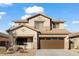 Traditional two-story home showcasing well-maintained front yard, two-car garage, and neutral color palette at 44250 W Vineyard St, Maricopa, AZ 85139