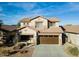 Inviting two-story home with an attached two-car garage and well manicured lawn at 44250 W Vineyard St, Maricopa, AZ 85139