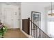 Upstairs hallway showcasing railing, carpet, and artwork at 44250 W Vineyard St, Maricopa, AZ 85139
