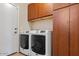 Modern laundry room with newer appliances, and built-in storage at 44250 W Vineyard St, Maricopa, AZ 85139